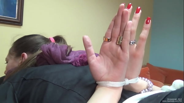 damsel tied up in restrain bondage with palms out